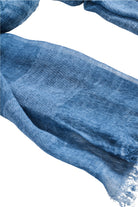Close-up of the frayed raw edge of the lake blue scarf