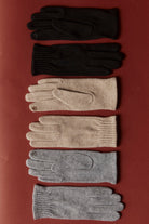 Berber gloves laid out in black, camel and grey shades