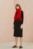 Full-length black outfit with the Raving Red scarf draped down the front