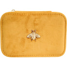 Straight-on view of the mustard velvet jewellery travel case with gold bee
