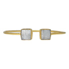 Fine gold cuff bangle with a square milky white moonstone at each end