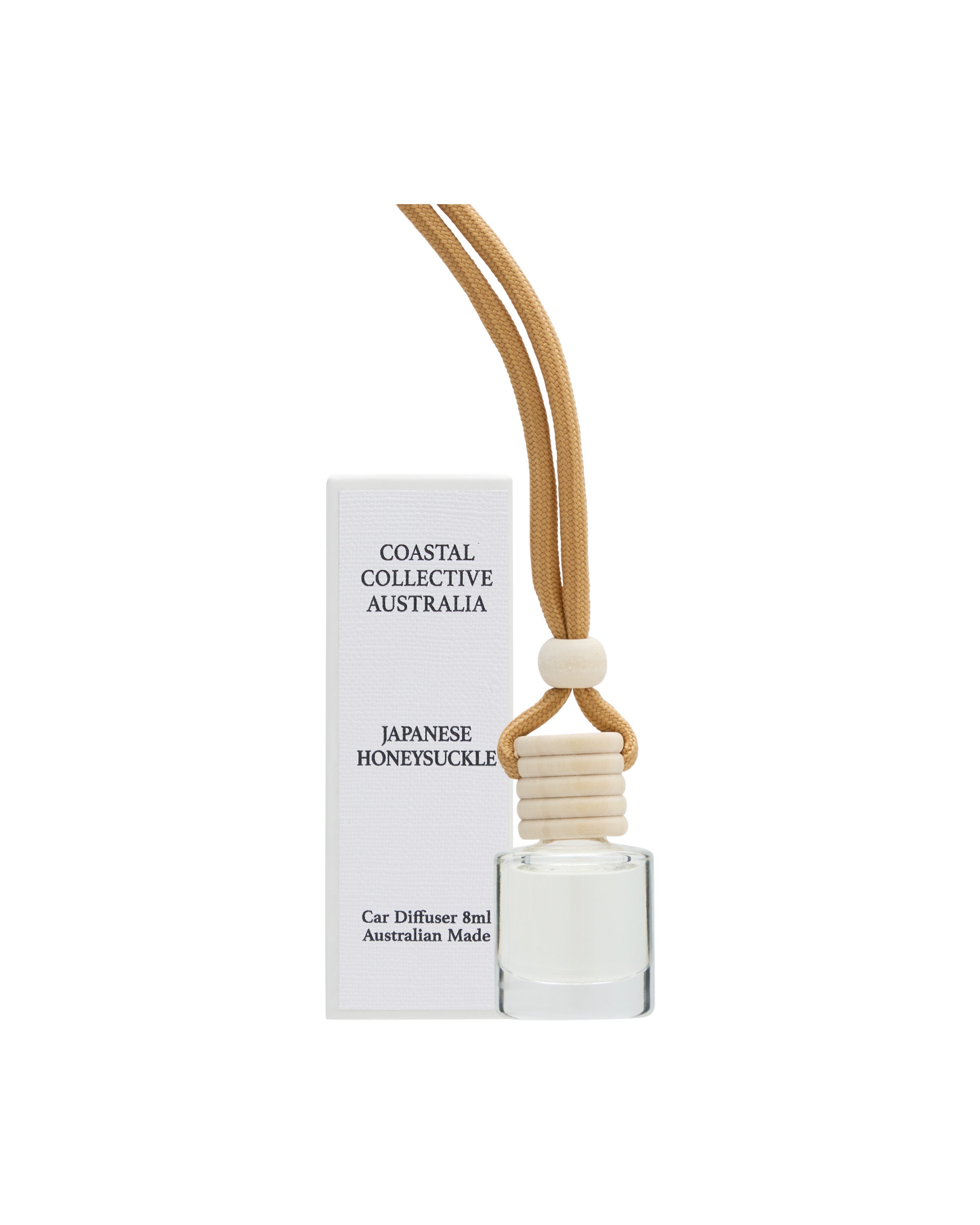 Car diffuser in Japanese Honeysuckle, bottle on a tan cord beside its box.