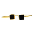 Fine gold cuff bangle with a square black onyx at each end