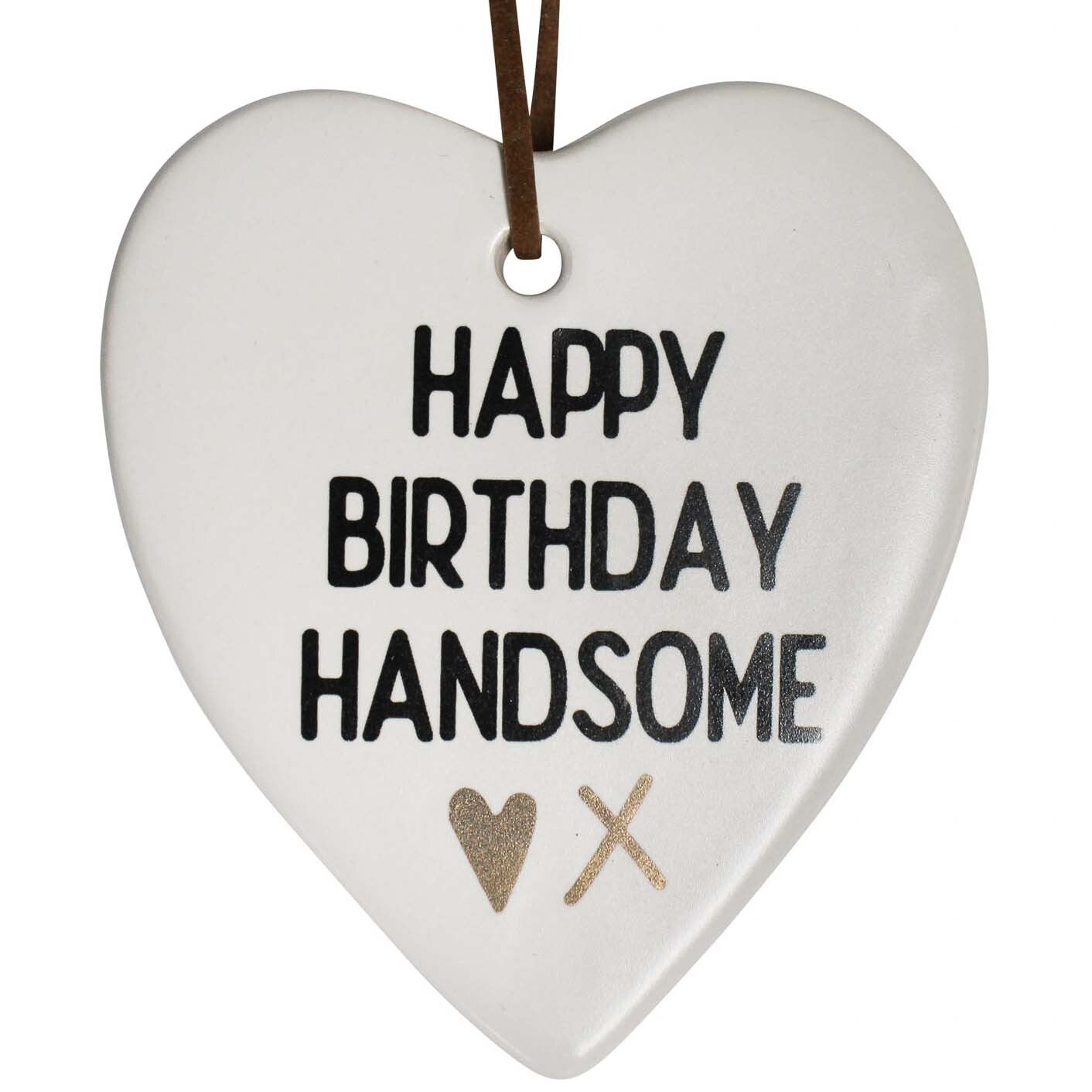 White ceramic heart printed Happy Birthday Handsome with gold heart and kiss, hung on a brown leather cord