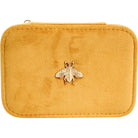Front of the closed mustard velvet case with gold bee embellishment