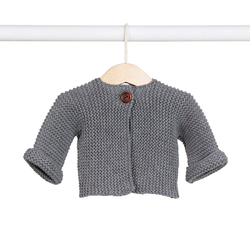 Charcoal cardigan on a wooden hanger, its cuffs turned back.
