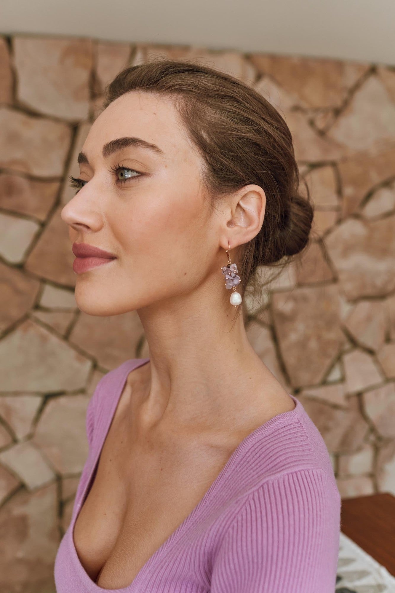 The Lilac earring worn in profile with a lilac knit top