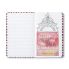 Open journal with airmail-striped lined pages and a watercolour quote about falling in love with Paris