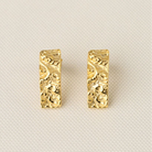 Close view of the pair of Bella gold earrings showing the crushed-metal texture