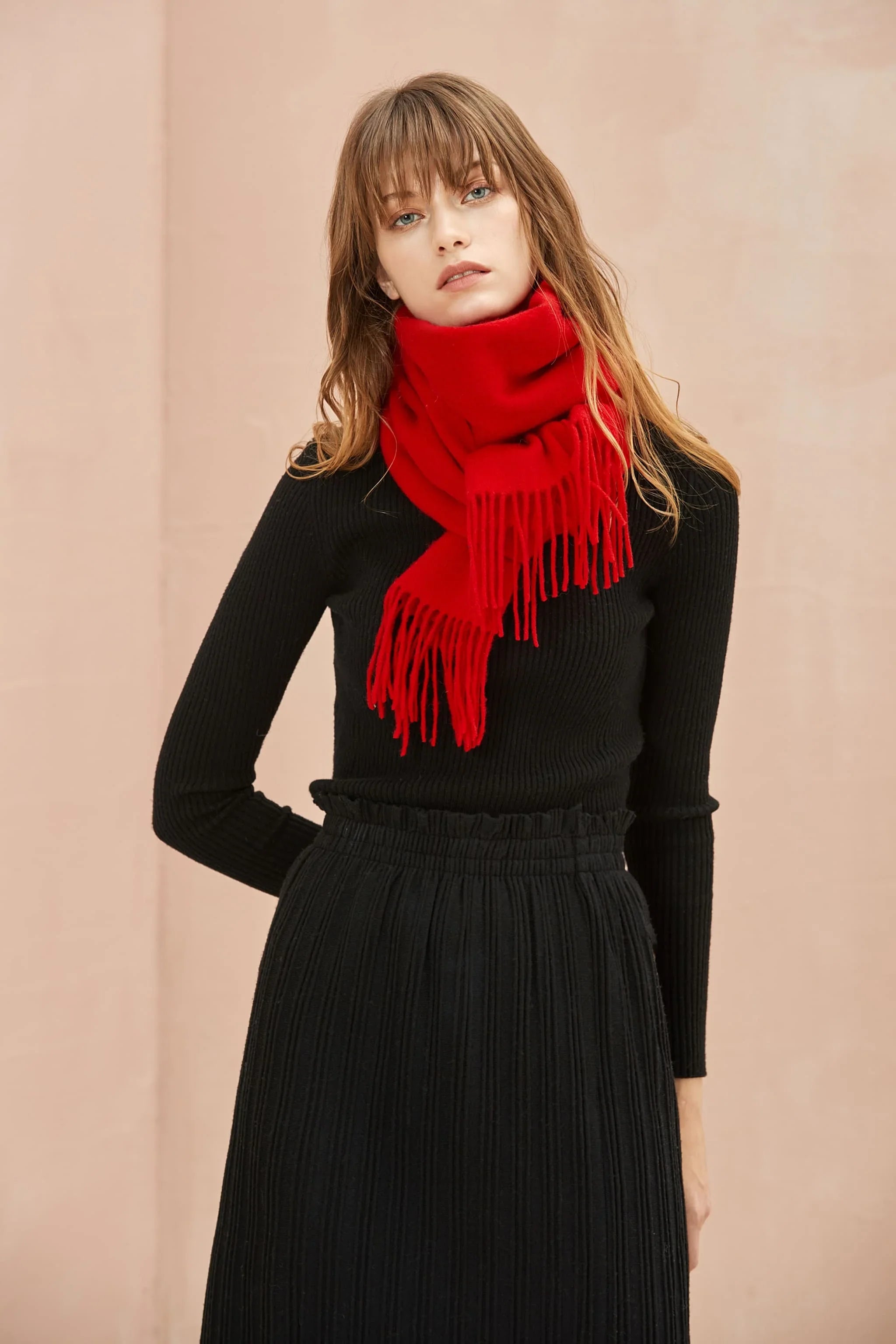 Raving Red scarf worn tucked at the neck over a black top