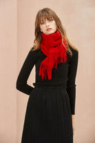Raving Red scarf worn tucked at the neck over a black top
