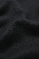 Texture close-up of the Ebony black merino weave