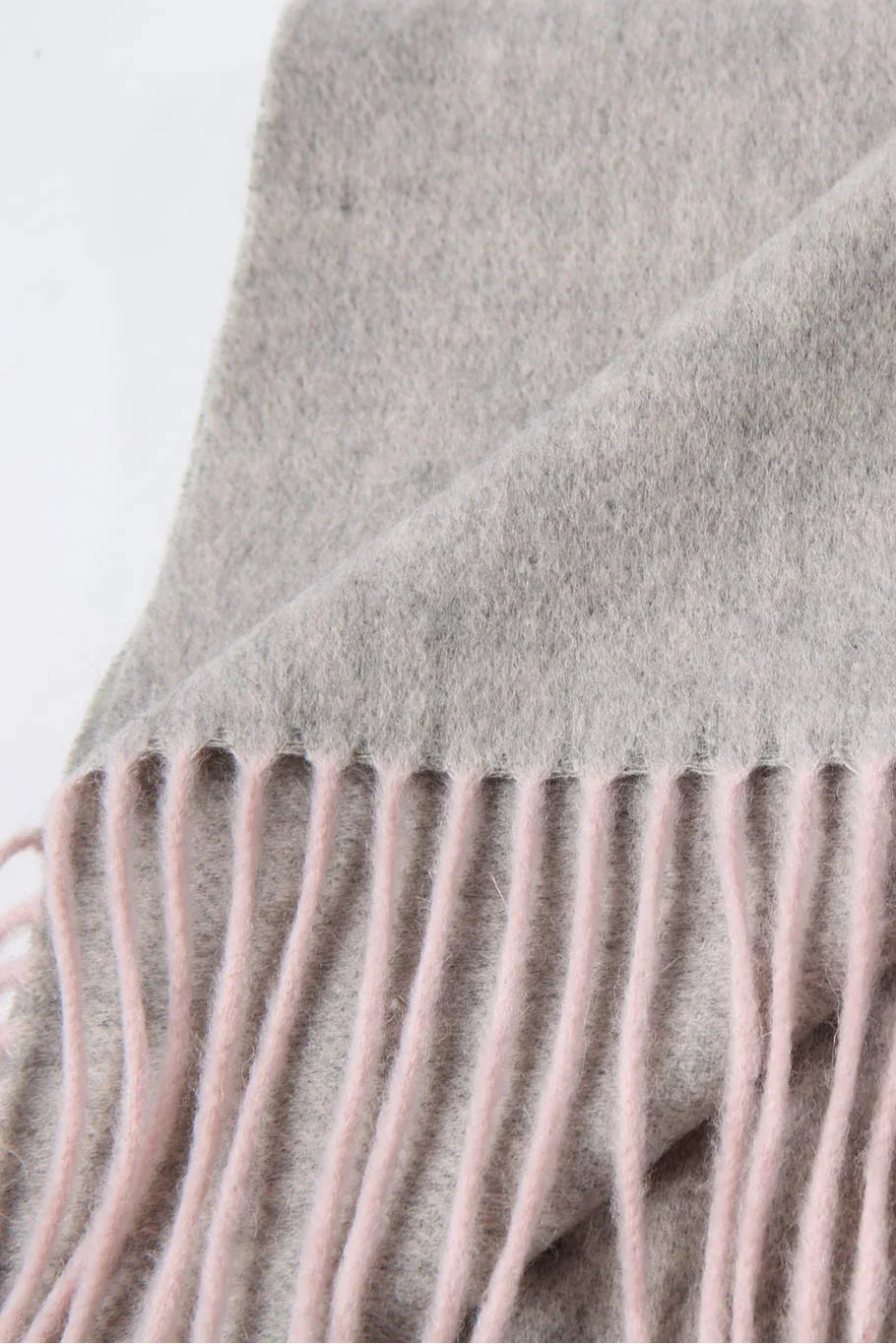 Fringe close-up of the Quartz Pink scarf in grey and blush