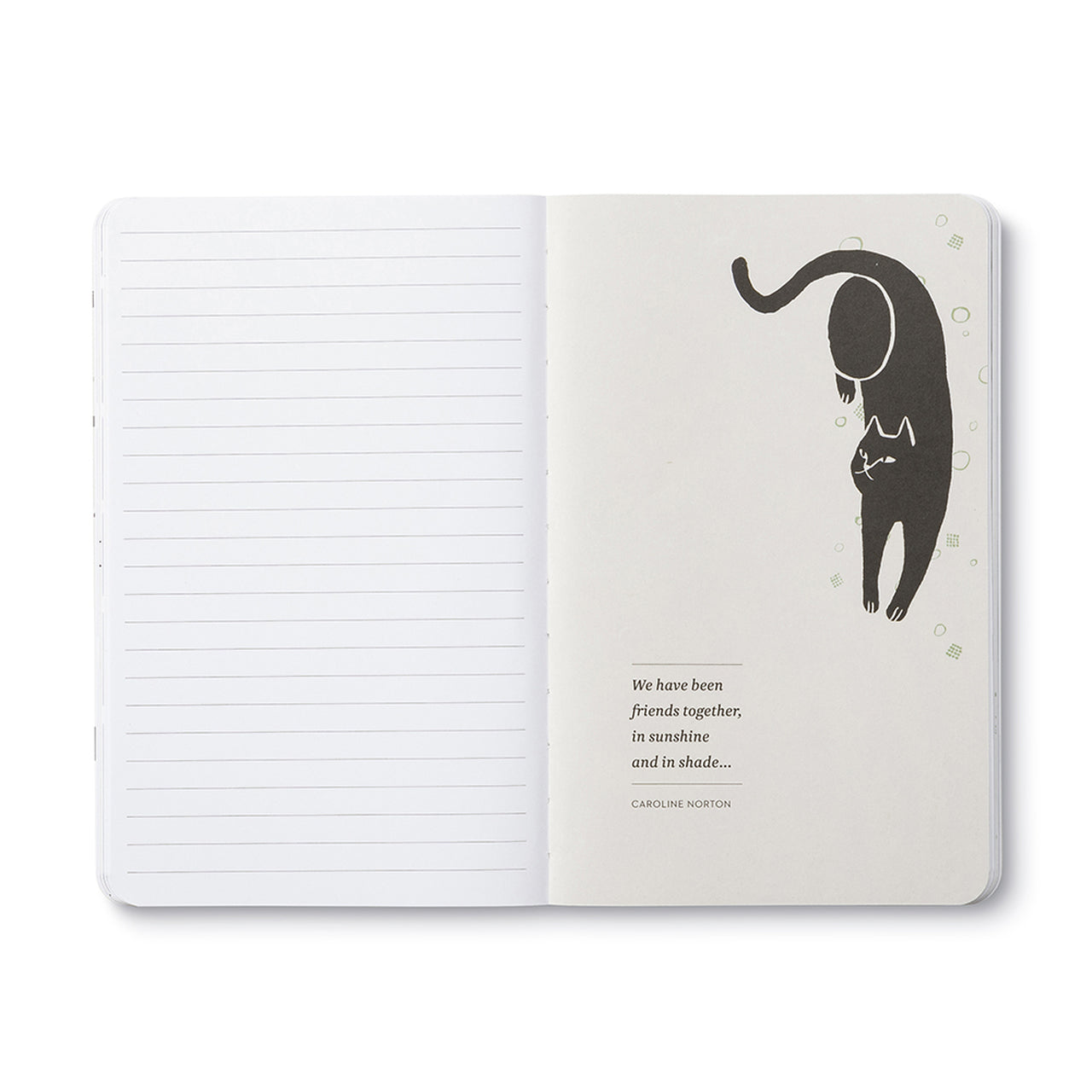 Open journal with lined pages beside a cream page of a stretching black cat above a short quote