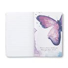 Open journal with lined pages beside a pink watercolour butterfly and a short quote