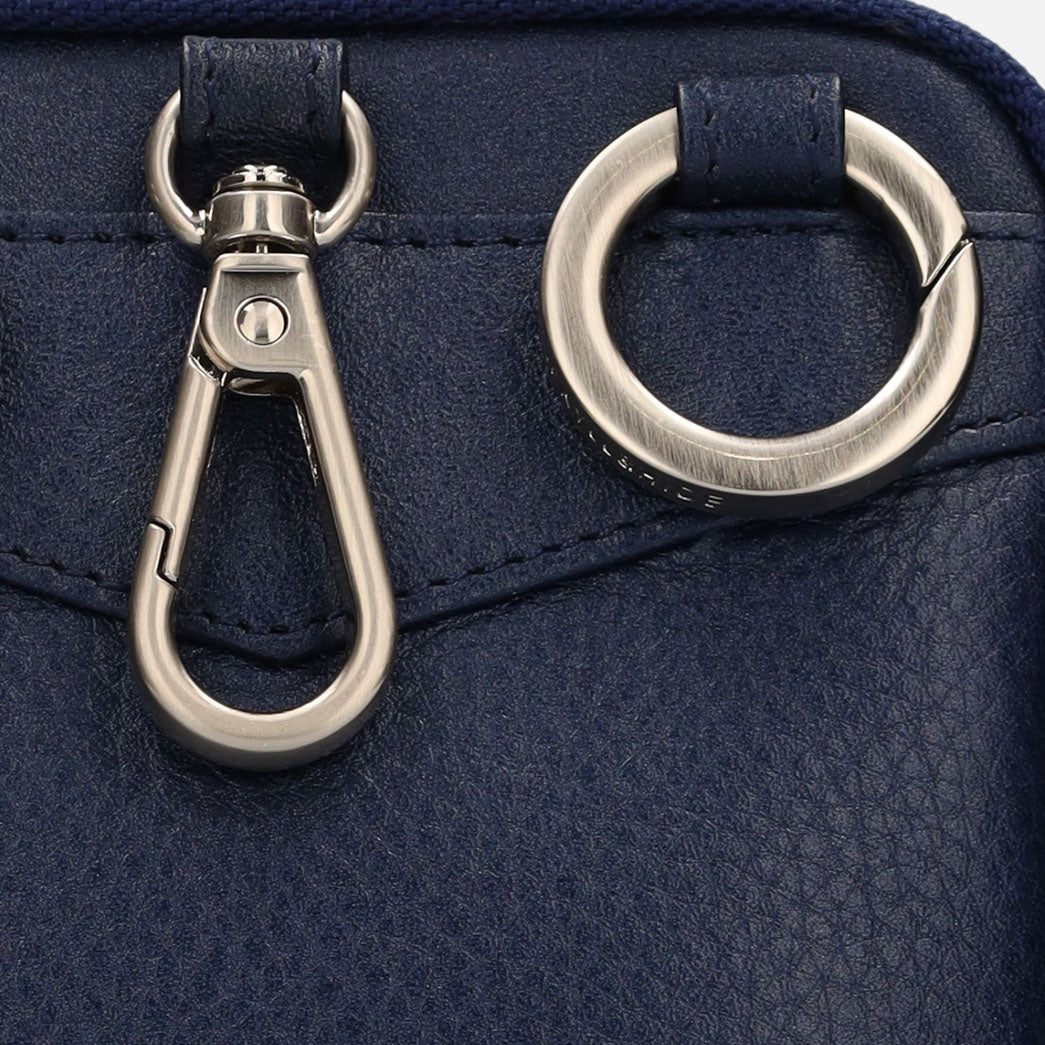 Close-up of the navy pouch silver clip and ring hardware