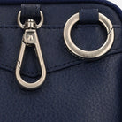 Close-up of the navy pouch silver clip and ring hardware