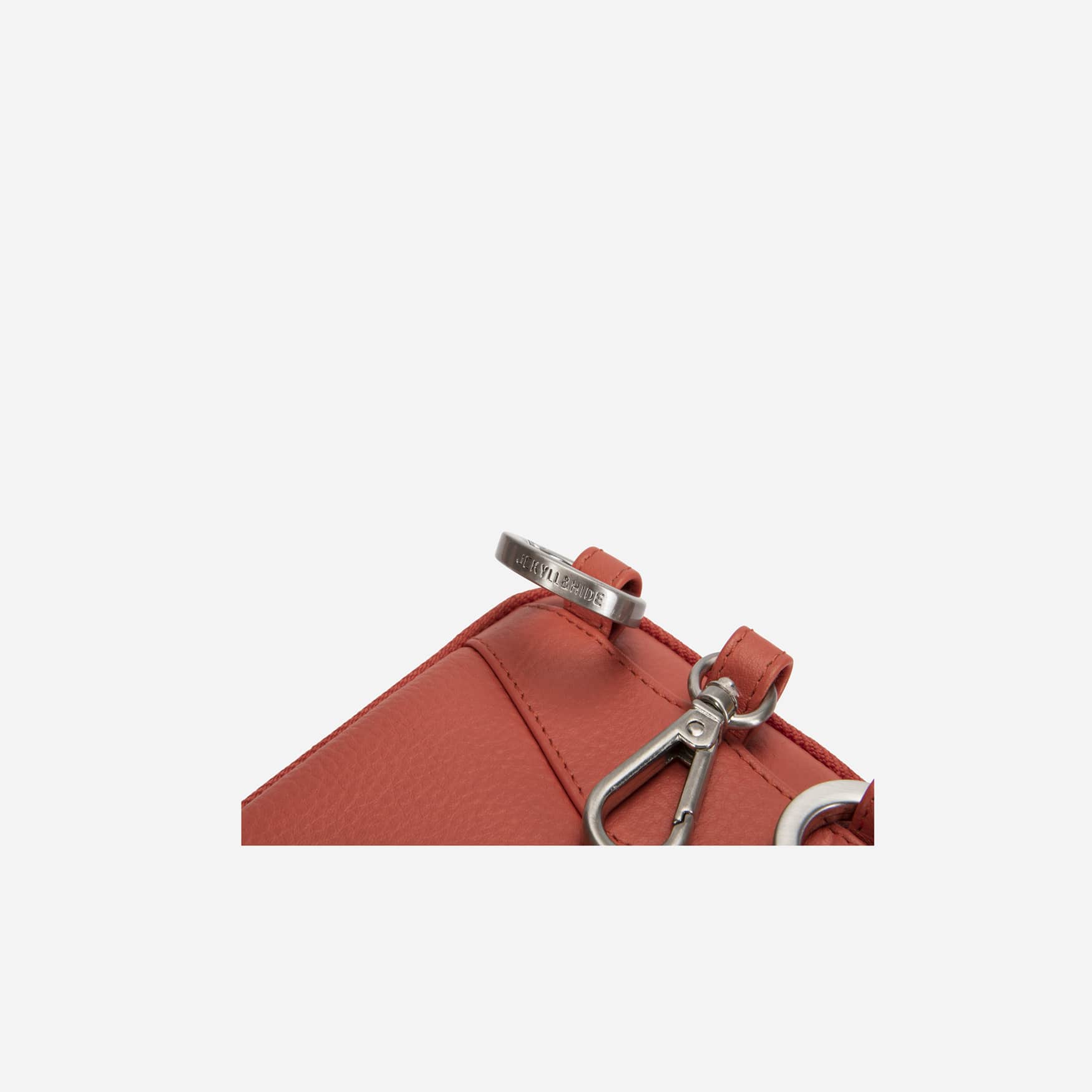 Close-up of the apricot pouch strap clip and ring hardware