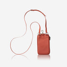 Apricot leather phone pouch hanging from its crossbody strap