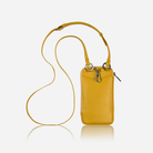 Yellow leather phone pouch hanging from its crossbody strap