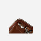 Corner close-up of the tan pouch zip and strap clip