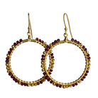 Overlapping gold hoop earrings wire-wrapped with wine-red ruby beads