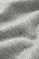 Texture close-up of the Quartz light grey merino