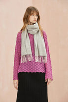 Full-length look with the Quartz Pink grey scarf over a magenta jumper and black skirt