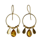 Fine gold hoop earrings with a faceted golden brandy topaz teardrop between two gold petals
