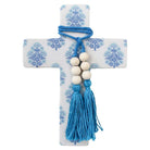 White cross with blue block-print motif, wrapped in blue cord with wooden beads and tassels