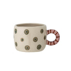 Cream stoneware cup painted with olive green dots, with a round red and pink striped handle