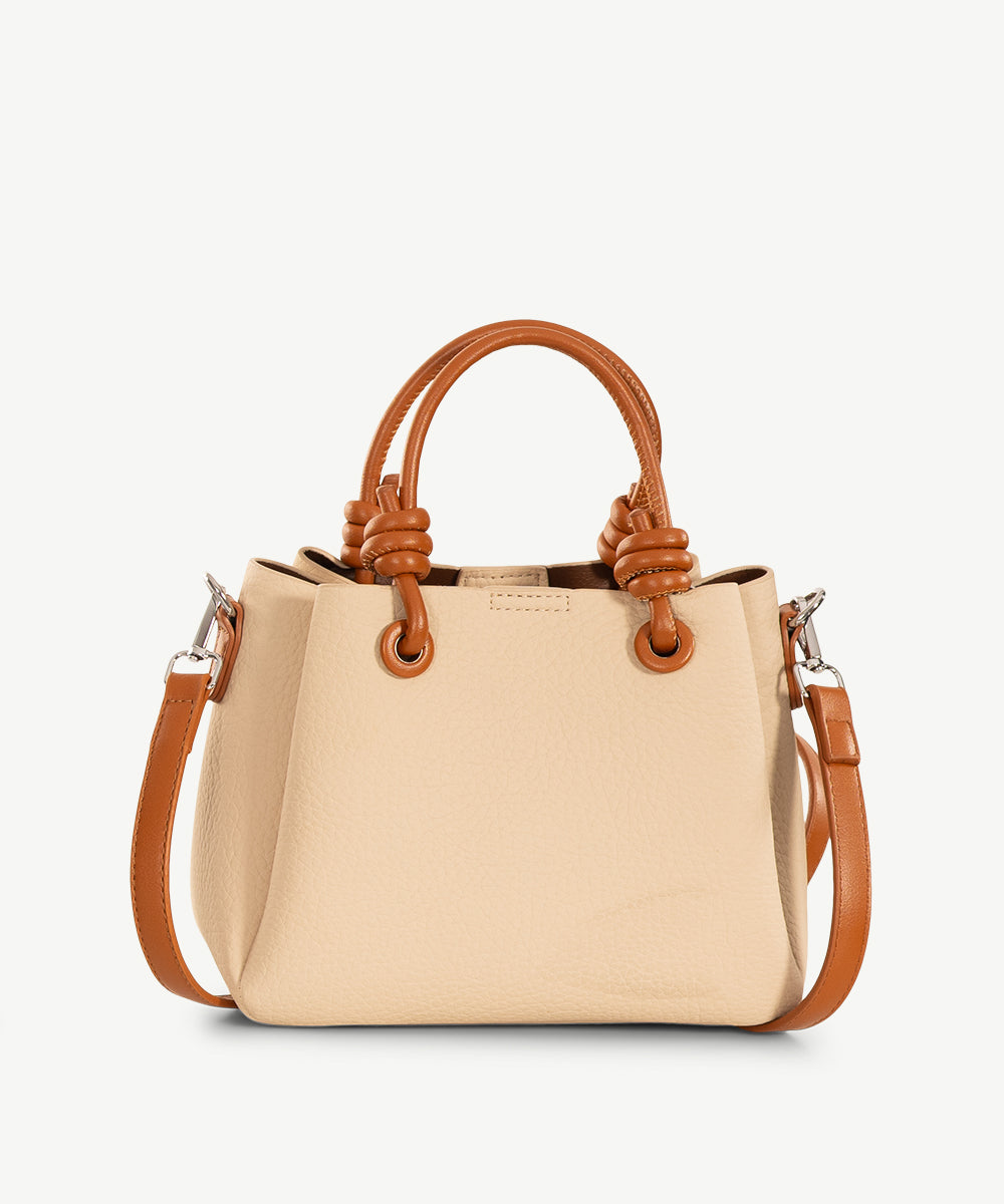 Cream stone-coloured grained faux leather cross body bag with tan handles and a tan strap.