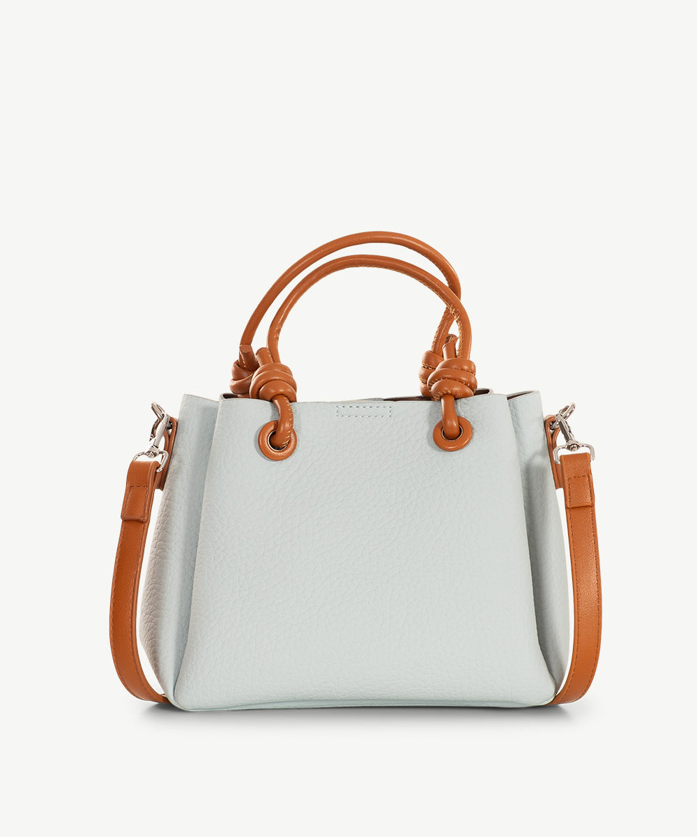 Pale ice blue grained faux leather cross body bag with tan handles and a tan strap.