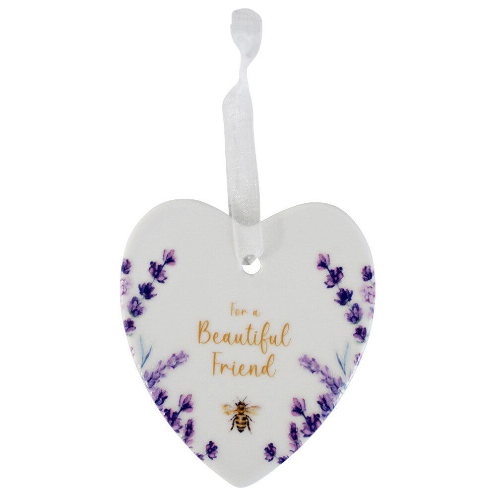 White ceramic heart with lavender sprigs, gold bee and For a Beautiful Friend message, on a sheer ribbon