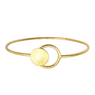 Fine gold wire bangle with a brushed round disc and an open loop at the front
