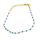 Fine gold bracelet with faceted turquoise-blue beads on a delicate chain