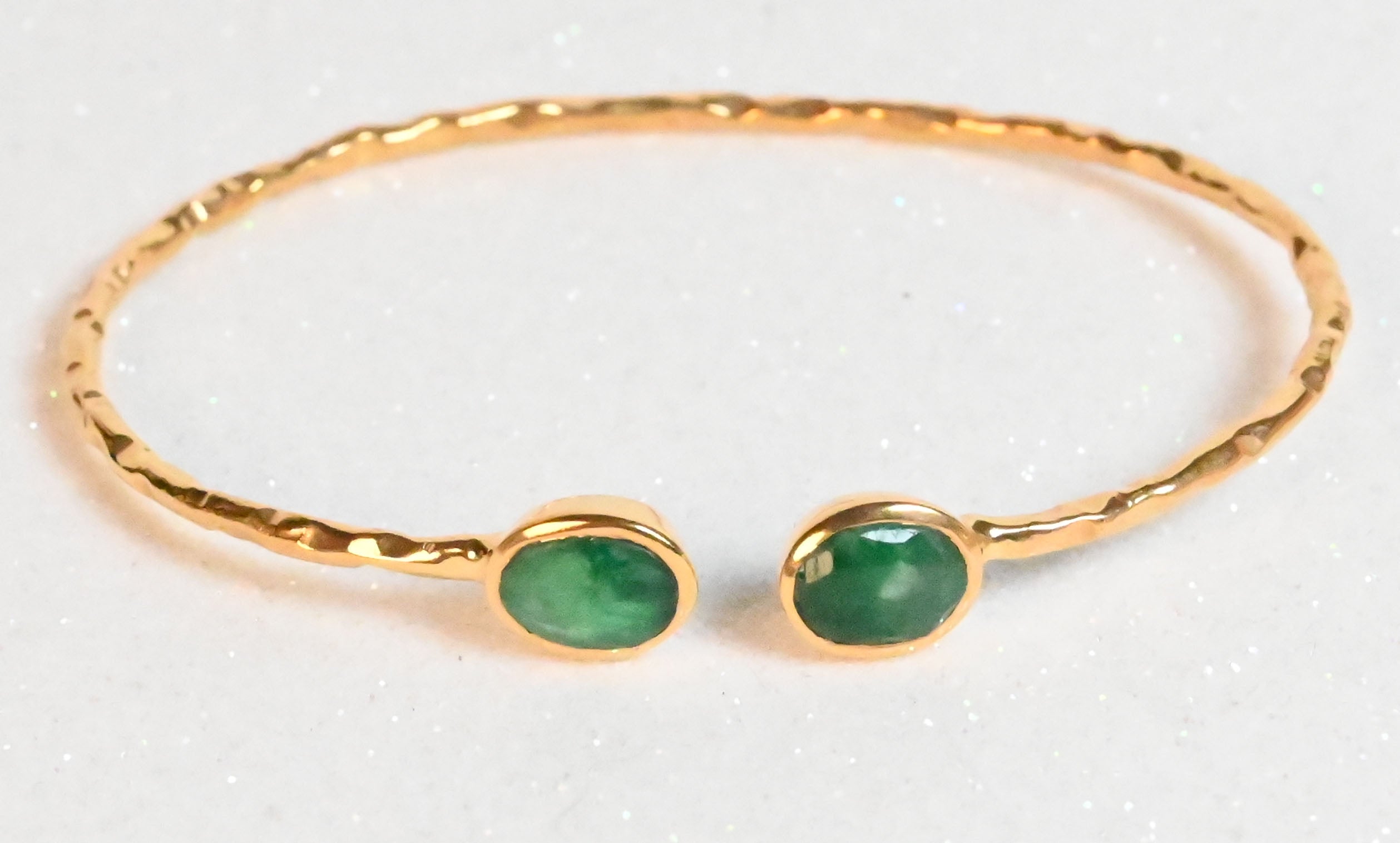 Euro Gold hammered cuff bangle with two emerald-green gems on white