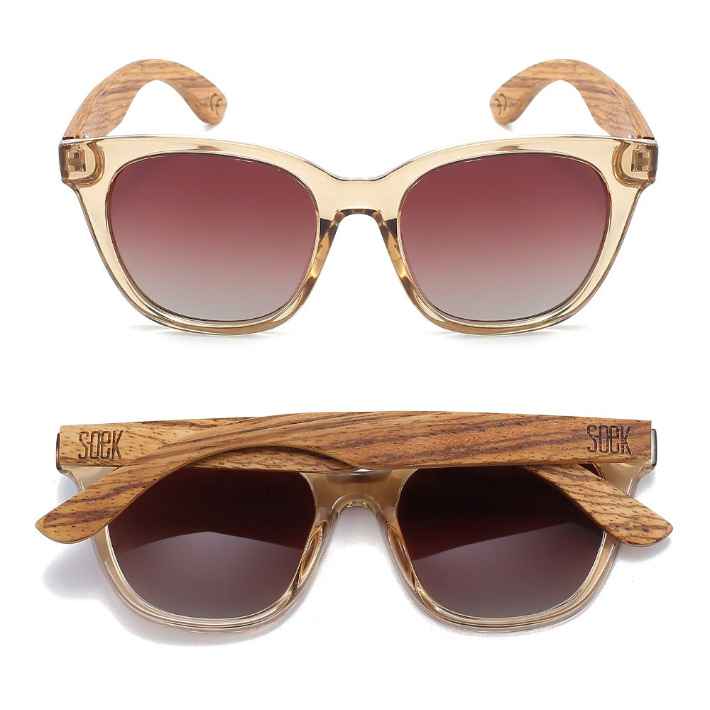 Two pairs of Lila Grace sunglasses in champagne, one front-on and one folded, showing the wood arms