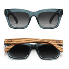 Two pairs of Morgan sunglasses in indigo blue, one front-on and one folded, showing the grained wood arms