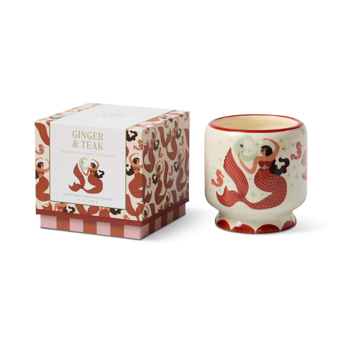 Cream ceramic candle painted with a red-tailed mermaid beside a crescent moon and seahorses, next to its matching Ginger & Teak gift box.