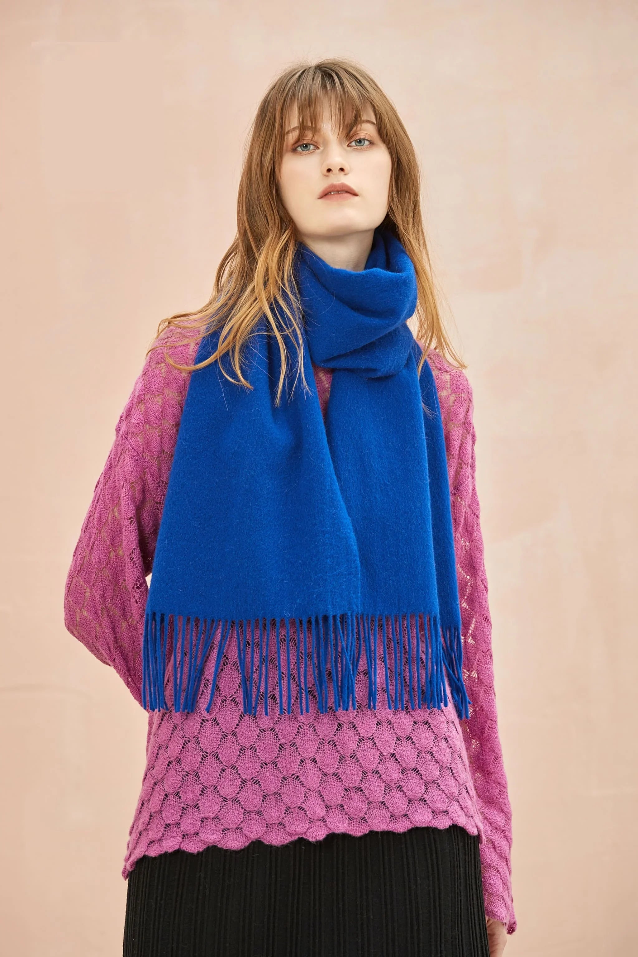 Model in a pink lace jumper wearing the Veronica Blue cobalt merino scarf