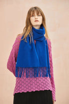 Model in a pink lace jumper wearing the Veronica Blue cobalt merino scarf