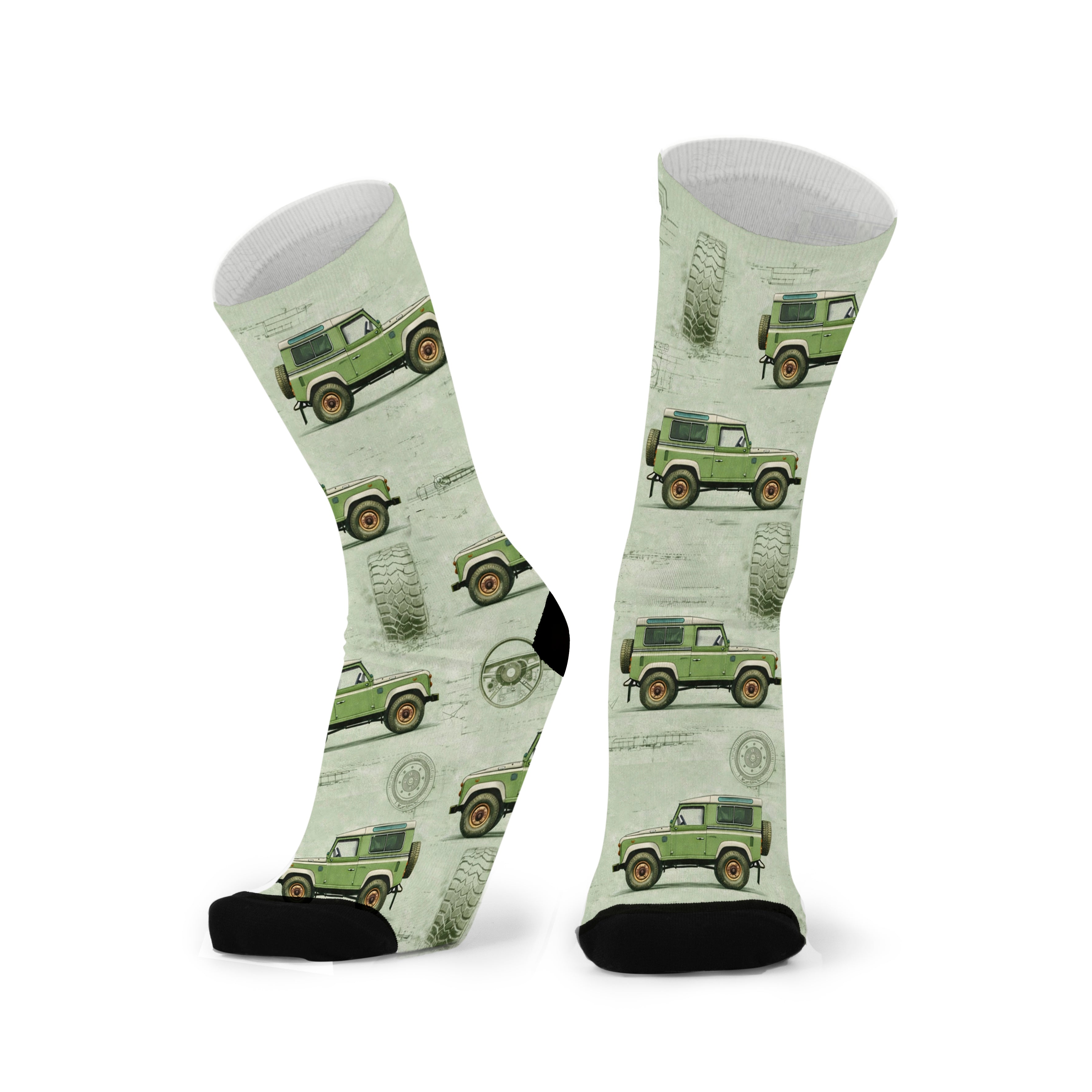 Pair of dusty olive green socks with black toes, printed with boxy four-wheel drives and faint technical blueprint linework.