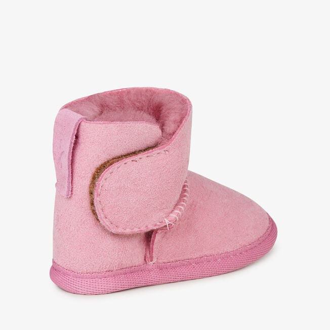 Orchid pink baby bootie with touch-tape strap fastened, angled view