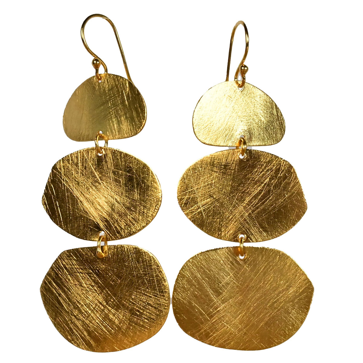 Brushed gold earrings with three graduated organic discs on a fine hook