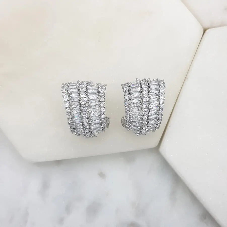Cubic zirconia cluster earrings viewed from the side on a marble tile