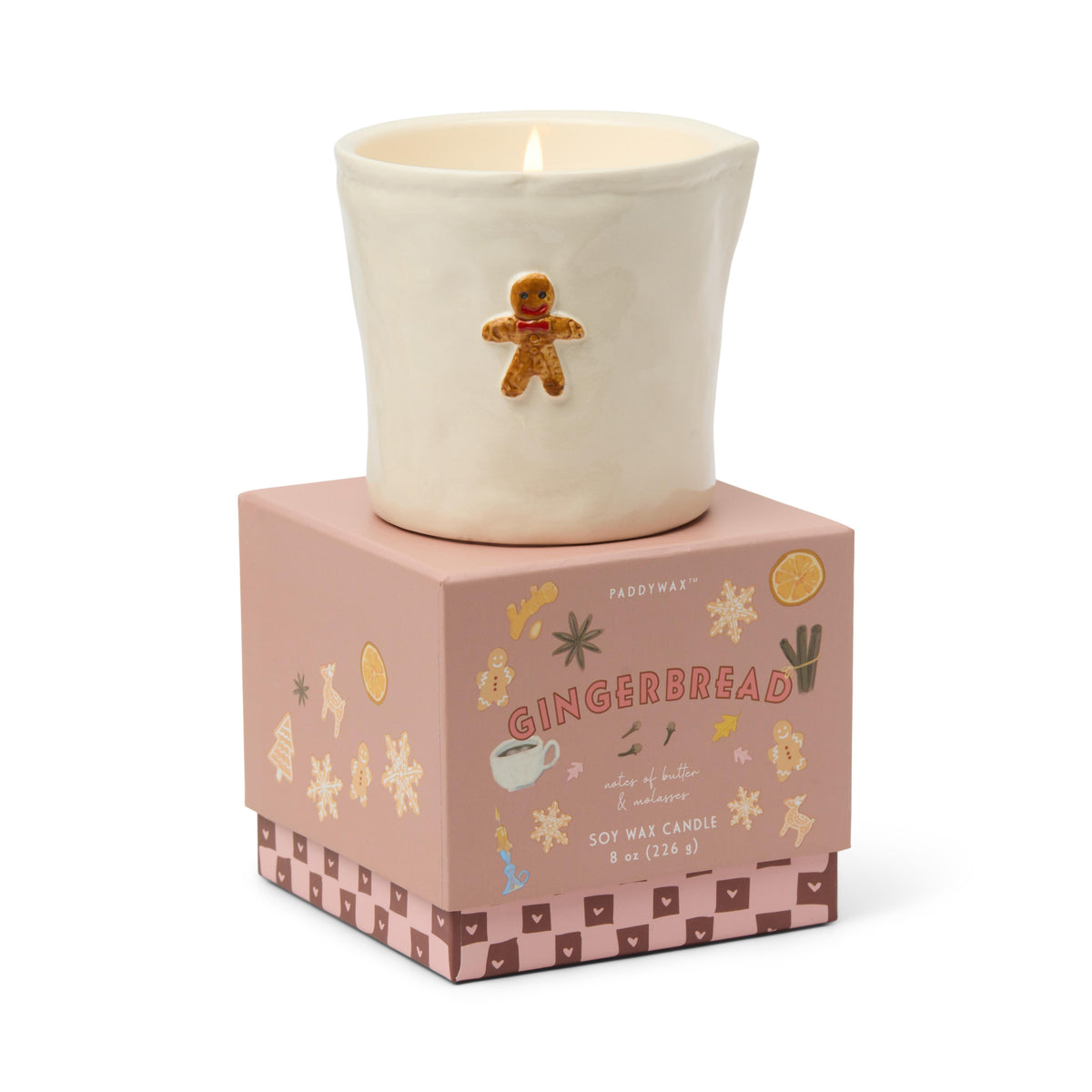 The gingerbread candle sitting on top of its closed pink gift box.