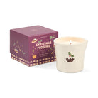 The Christmas pudding candle beside its plum gift box printed with puddings, holly and spices.