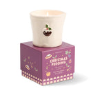 The Christmas pudding candle sitting on top of its closed plum gift box.