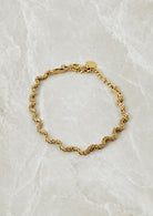 Gold curb-link chain bracelet with softly curved links and a lobster clasp